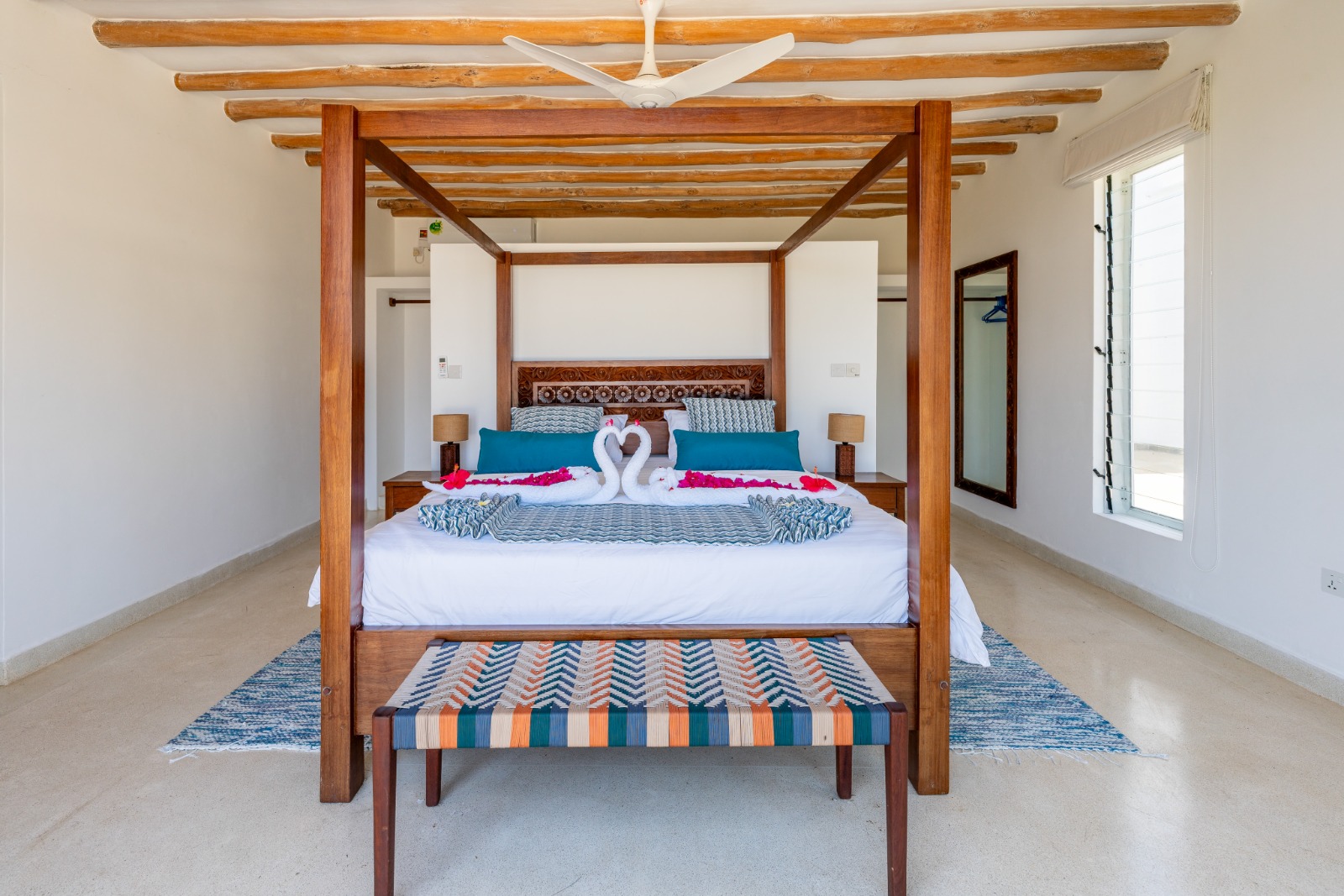 Four-poster bedroom with white linens