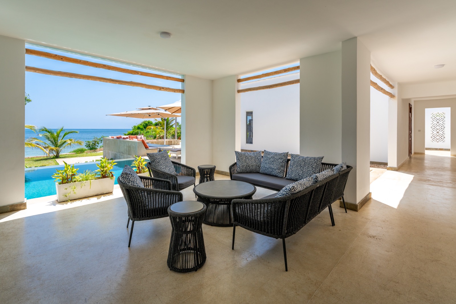 Shaded terrace seating overlooking the pool and Indian Ocean